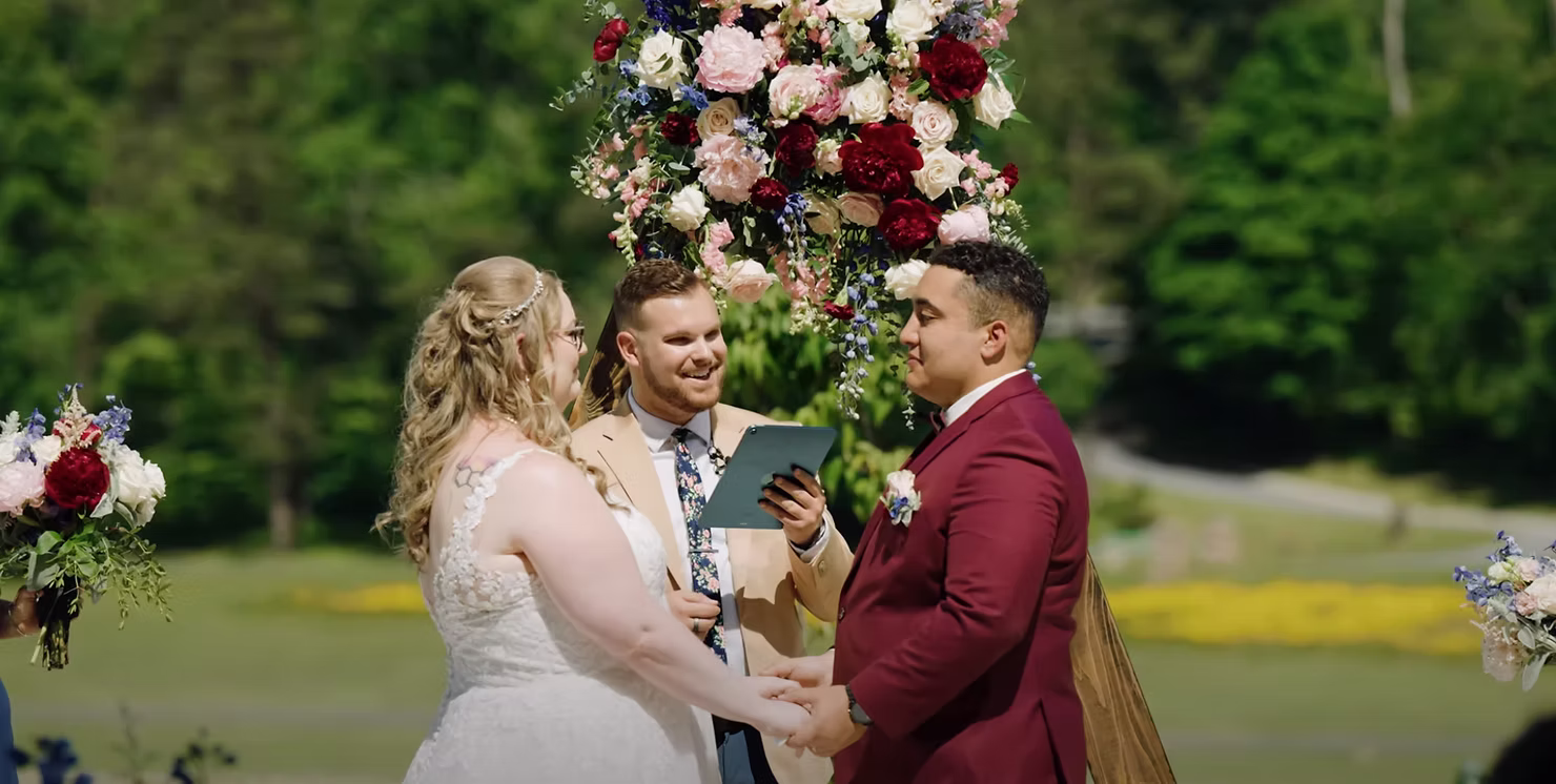 Bride and groom exchanging vows with their officiant
