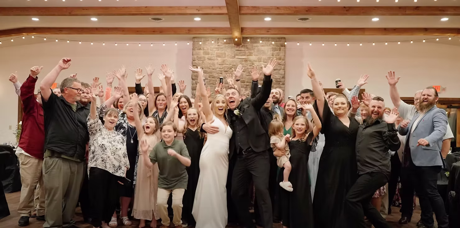 Joyful wedding reception with bride, groom, and guests celebrating