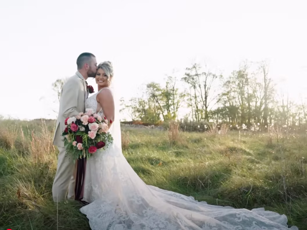 Bride and groom in a scenic outdoor pasture setting