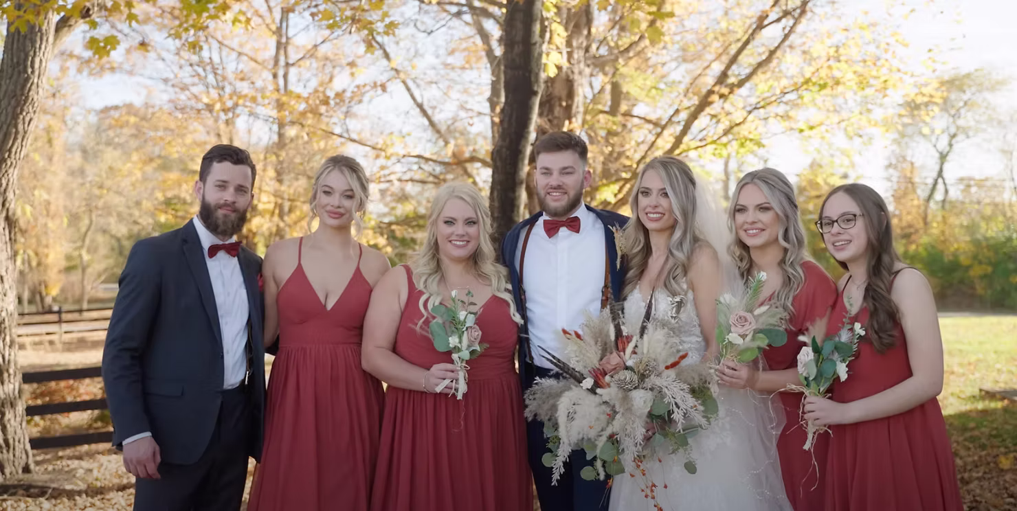 Wedding party of eight posing together outdoors