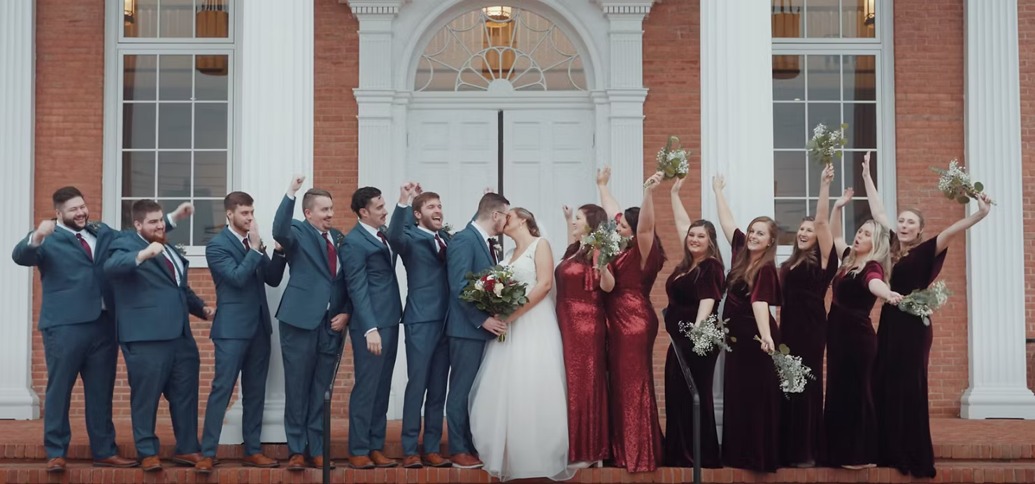 Formal wedding party photograph with bride and groom