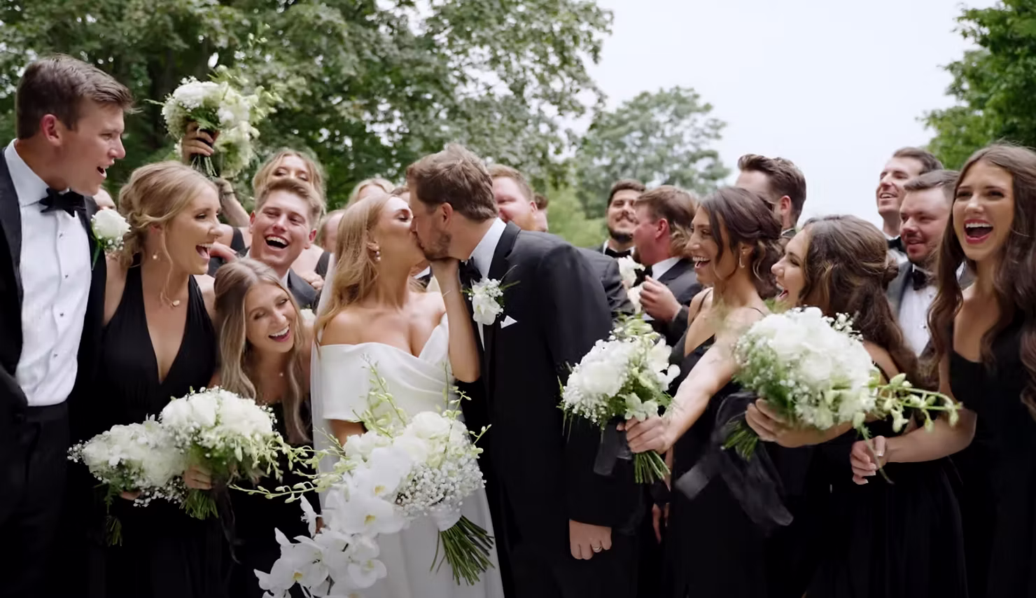 Bride and groom with their wedding party in formal attire